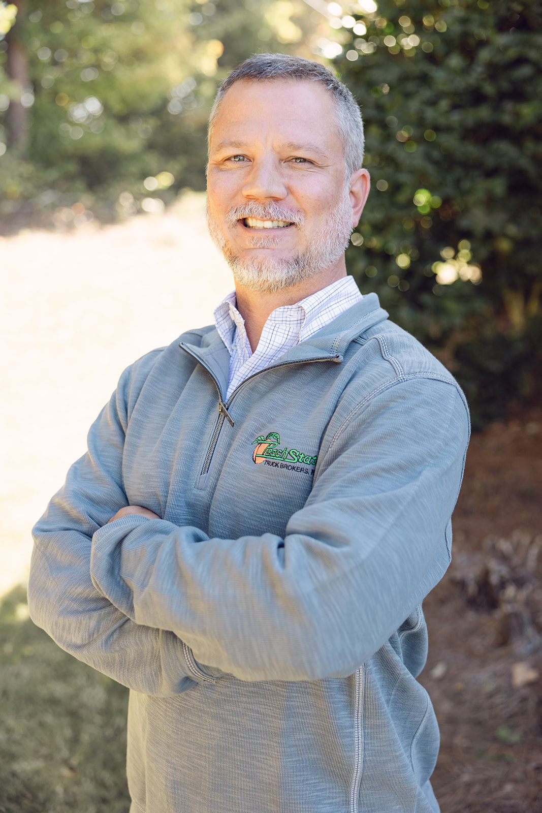 A man standing in front of some trees