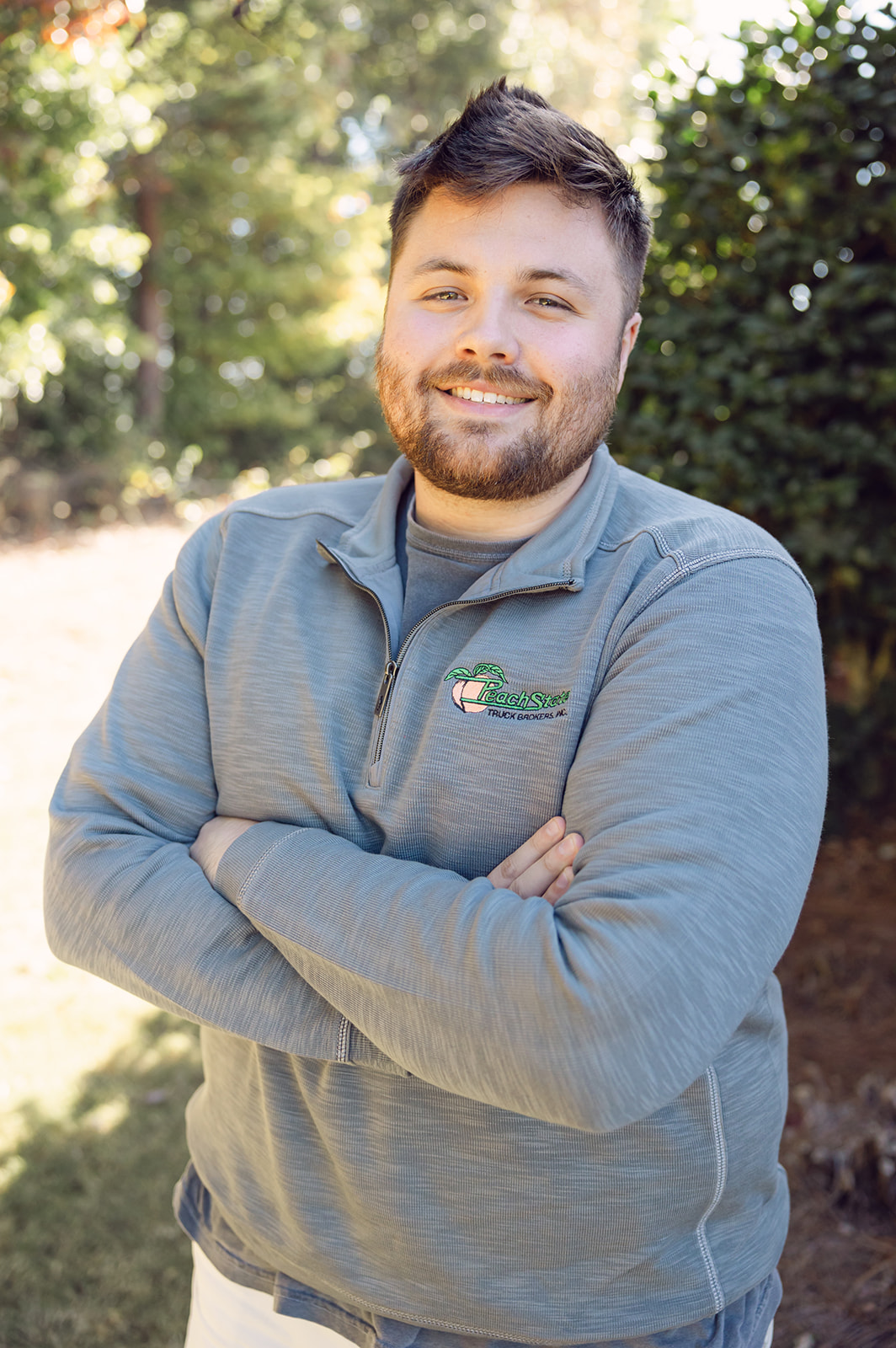 A man standing in front of some bushes